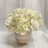 White hydrangea and carnation arrangement in a ceramic pot