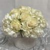 Cream roses and white hydrangeas in a white vase