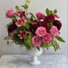 This arrangement has a refined, garden-inspired elegance with a rich, romantic color