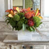 Orange and yellow calla lilies with pink-orange pincushions, Protea and bright green