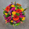 Bright mixed bouquet with orange gerbera daisies, pink roses, and yellow ranunculus