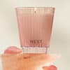 Pink Nest New York candle in a translucent holder with rose petals