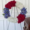 This wreath features a bold yet balanced blend of rich red roses