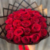 Bouquet of red roses wrapped in black paper with a red ribbon