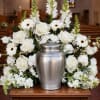 White floral funeral urn arrangement with roses and daisies