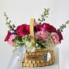 A stunning, hand-arranged bouquet bursting with vibrant magenta roses, delicate blush carnations