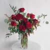 A show-stopping take on the traditional dozen rose arrangement. Unique greenery is