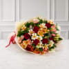 Bouquet of red roses and pink alstroemeria wrapped in pale paper