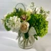 Green and white bouquet with roses and orchids in a glass vase