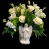 White roses and lilies arranged in a ceramic angel vase