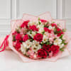 Bouquet of red roses and white-pink alstroemeria wrapped in pink paper