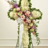 Standing floral spray with white and pastel flowers on a white ribboned easel