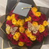 Bouquet of red and yellow roses with butterfly decorations and a graduation cap