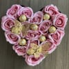 Heart-shaped arrangement of pink roses with gold-wrapped chocolates and butterfly picks