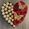 Heart-shaped box with red roses and gold-wrapped chocolates