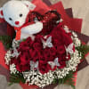Red rose bouquet with a teddy bear holding a heart and butterfly picks