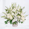 Evensong is a serene all-white sympathy flower arrangement designed with elegant lilies