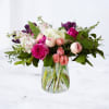 Mixed pink and white flowers in a clear glass vase