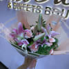 Pink lilies and carnations in a wrapped bouquet