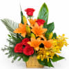 Basket arrangement of red roses, orange lilies, and yellow orchids