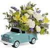 Floral arrangement in a turquoise vintage truck container