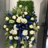Blue funeral arrangement. A total of 24 roses are in this arrangement