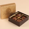 Small box of assorted milk chocolates in an open brown and gold gift box