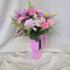 Pink and purple mixed bouquet arranged in a bright pink handled travel tumbler