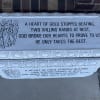 White memorial plaque with an angel illustration and a sympathy verse