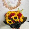 Bouquet of yellow sunflowers and red roses wrapped in black paper