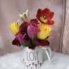  A romantic and delicate floral arrangement presented in a charming LOVE