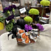 Halloween floral basket with purple carnations and green chrysanthemums