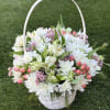 White and pink flower basket with a curved handle