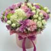 Pink and white mixed bouquet in a round box with a ribbon