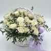 White rose bouquet in a white basket with a lavender ribbon