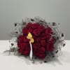 Bouquet of red roses with delicate filler and heart-patterned wrap