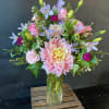 Pink and lavender mixed bouquet in a clear glass vase