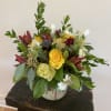 Mixed bouquet of yellow and white roses in a glass vase