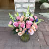 Soft blush roses and peach spray roses create an immediate sense of