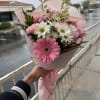 Pink bouquet with gerbera daisies and white daisy flowers wrapped in pink paper