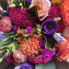 Colorful bouquet with roses, dahlias, and purple blooms