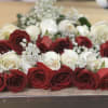 18 red and white long stem roses prepared presentation style with greens