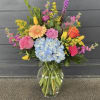 This neon vase is made up of Hydrangeas, Roses, Gerbera Daisys, Carnations