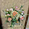 Blush roses and white hydrangeas arranged in a decorative vase