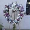 Our Blue and Lavender Heart-Shaped Sympathy Wreath Easle includes white casablanca lilies