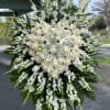 Large white funeral spray with roses and lilies