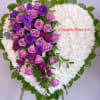 Heart-shaped floral wreath with pink and purple roses on white blooms