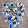 Blue and white floral wreath on a wooden stand