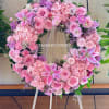 Pink and lavender floral wreath on a wooden easel