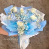 Bouquet of white roses with baby's breath wrapped in blue paper